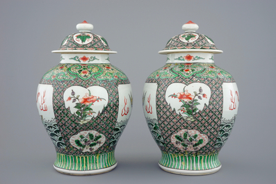 A pair of Chinese famille verte vases and covers with mythical beasts, 19/20th C.