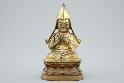 A Sino-Tibetan gilt bronze figure of a Lama on a double lotus throne, 19th C.