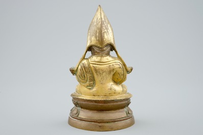 A Sino-Tibetan gilt bronze figure of a Lama on a double lotus throne, 19th C.