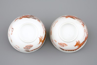 A pair of Chinese cups and saucers with dragons in iron red and gilt, Yongzheng, 1723-1735