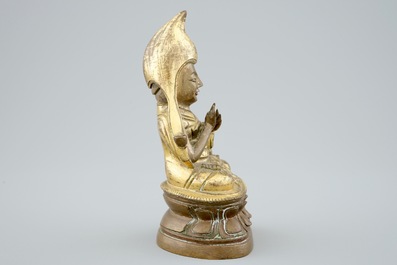 A Sino-Tibetan gilt bronze figure of a Lama on a double lotus throne, 19th C.