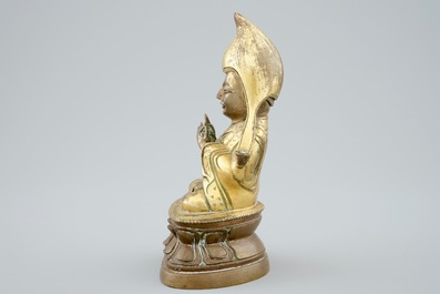 A Sino-Tibetan gilt bronze figure of a Lama on a double lotus throne, 19th C.