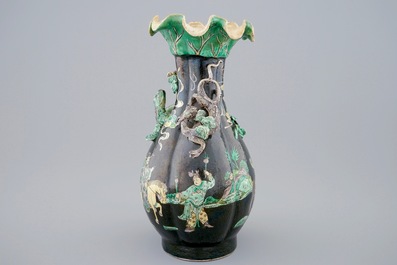 A Chinese famille noire lotus-shaped vase with applied dragons, 19th C.