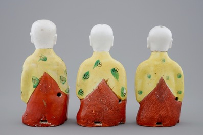 A set of three Chinese porcelain figures of kneeling boys, 19th C.