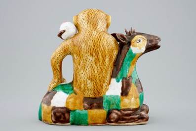 A Chinese famille verte biscuit ewer in the shape of a monkey seated on a deer, Kangxi
