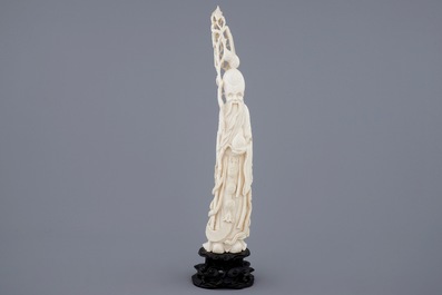 A Chinese ivory figure of Shou Lao on stand, late 19th C.