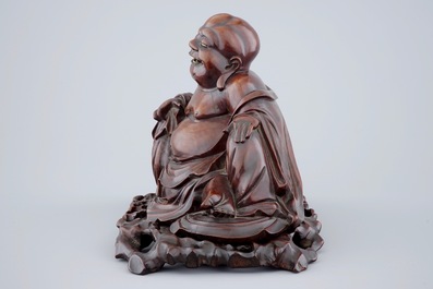 A large Chinese carved wood figure of Buddha on stand, 19th C.