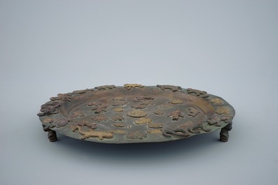 A copper alloy Buddhist alms tripod dish with applied animals, Asia, 19/20th C.