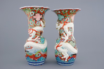 A tall pair of Japanese relief-moulded dragon vases, 19th C.