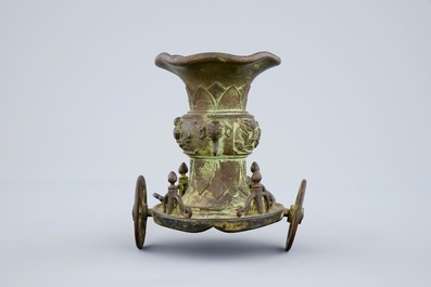 An unusual Chinese bronze vase on a chariot base, late Ming to Qing Dynasty