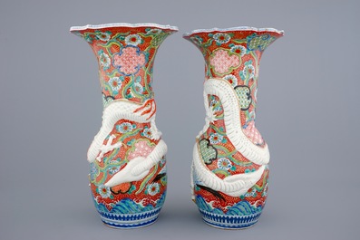 A tall pair of Japanese relief-moulded dragon vases, 19th C.