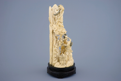 A Chinese carved ivory group of the moon goddess and 2 girls on a wooden base, 19/20th C.