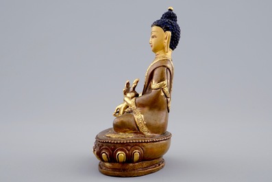 A Sino-Tibetan gilt bronze figure of a seated Buddha, 19/20th C.