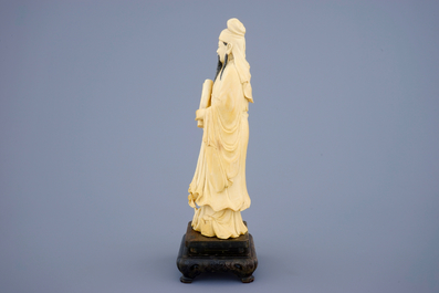 A Chinese ivory figure of a sage with a parchment roll on stand, late 19th C.