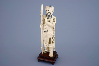 A Chinese carved ivory figure of a warrior on a wooden base, late 19th C.