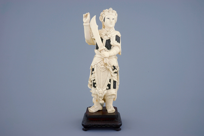 A Chinese carved ivory figure of a female warrior on a wooden base, late 19th C.