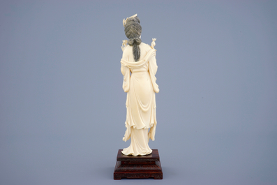 A large Chinese carved ivory figure of Guanyin on wooden base, early 20th C.