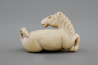 A signed Japanese ivory netsuke of a horse, 19th C.