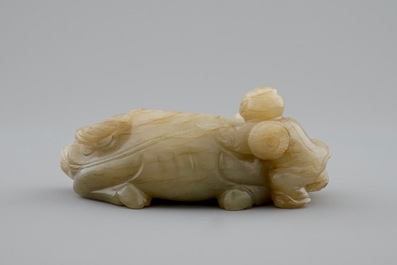 A Chinese jade group of a boy on a buffalo, 18/19th C.