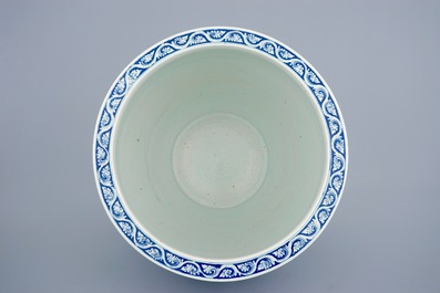 A Chinese blue and white flower scroll fish bowl, 19th C.