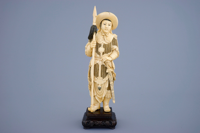 A Chinese carved ivory figure of a female warrior on a wooden base, late 19th C.