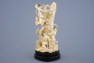 A Chinese carved ivory group of the moon goddess and 2 girls on a wooden base, 19/20th C.