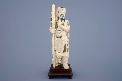 A Chinese carved ivory figure of a warrior on a wooden base, late 19th C.