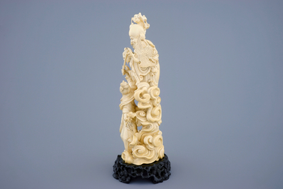 A Chinese carved ivory group of immortals on intricate wooden base, early 19th C.