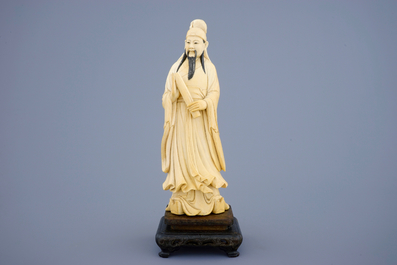 A Chinese ivory figure of a sage with a parchment roll on stand, late 19th C.