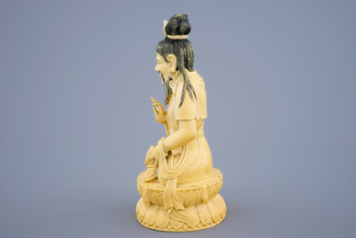 A Chinese carved ivory figure of a seated Buddha, 19th C.