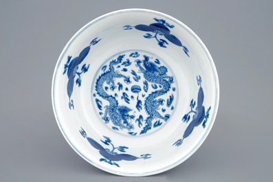 A Chinese blue and white dragon bowl with floral design, Kangxi