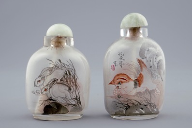 Two Chinese inside-painted glass snuff bottles with a cat and a tiger, 20th C.