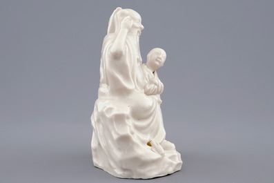 A Chinese Dehua blanc de Chine group of an immortal with a boy, 18/19th C.