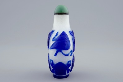 A Chinese blue and white overlay glass snuff bottle, 19th C.