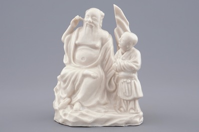 A Chinese Dehua blanc de Chine group of an immortal with a boy, 18/19th C.