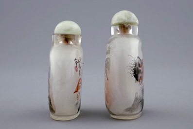 Two Chinese inside-painted glass snuff bottles with a cat and a tiger, 20th C.