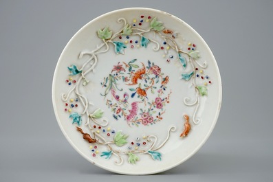 A Chinese relief-decorated famille rose cup and saucer with squirrels, Yongzheng, 1723-1735