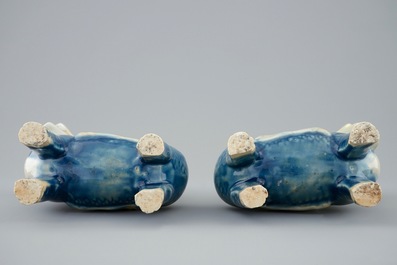 A pair of Chinese celadon, blue and white figures of the Immortal Twins, Hehe Erxian, riding a kylin, 18th C