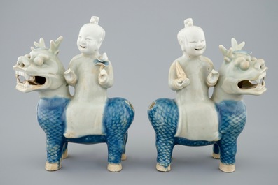 A pair of Chinese celadon, blue and white figures of the Immortal Twins, Hehe Erxian, riding a kylin, 18th C