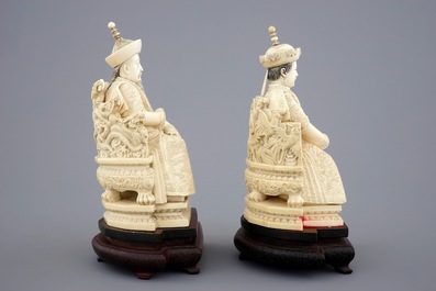 A pair of Chinese ivory figures of the emperor couple seated on a throne, ca. 1900