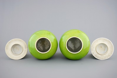 A pair of Chinese monochrome lime green vases and covers, 19/20th C.