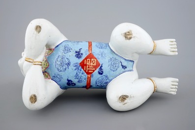 A large Chinese porcelain pillow in the form of a kneeling boy, 18th C.