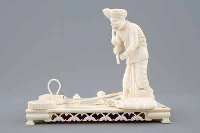 An Indian ivory group of a snake charmer on base, ca. 1900