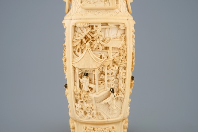 A very fine Chinese carved ivory vase and cover with figures in a landscape, ca. 1900