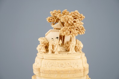 A very fine Chinese carved ivory vase and cover with figures in a landscape, ca. 1900
