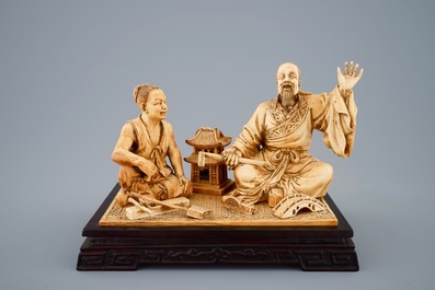 A rare Chinese carved ivory group of a carpenter with student, ca. 1900
