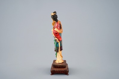 A polychrome Chinese carved ivory figure of Guanyin on wood base, 19th C.