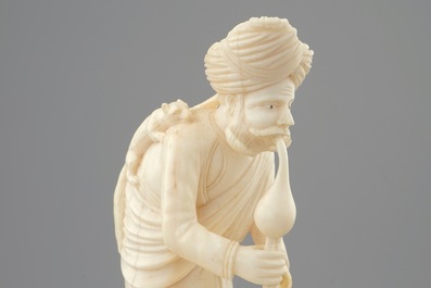 An Indian ivory group of a snake charmer on base, ca. 1900