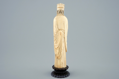 A Chinese carved ivory figure of a sage with a beaker on a lotus-shaped base, 19th C.