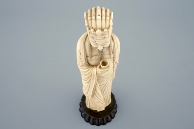 A Chinese carved ivory figure of a sage with a beaker on a lotus-shaped base, 19th C.